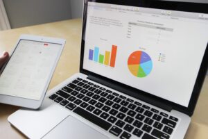 A laptop computer and tablet showing charts
